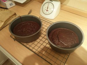 The baked cake pans on a cooling rack