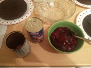 An empty can and a bowl of cherries