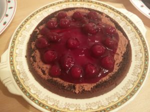 The base layer of the cake with the cherries spread out, and swapped onto a different plate