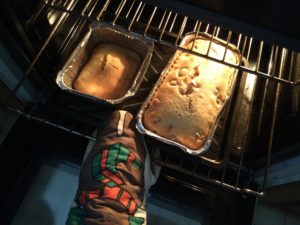 The caked have finished baking and are coming out of the oven