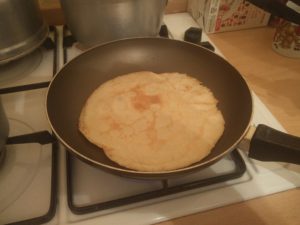 The pancake has been flipped over, for the other side to cook