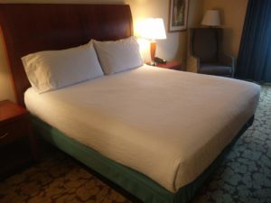 Another view of the room showing the large bed and seats