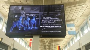 Another screen in the terminal building advertising Northrop Grumman's services