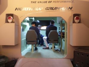 The students sitting in a replica of an armoured vehicle