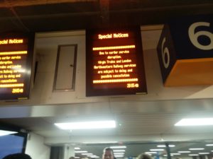 A display board showing a notice about delays and cancellations of train services
