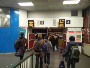 Our team of students walking down a ramp to the platform at London Euston station